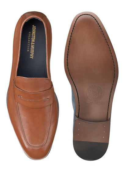 A pair of J & M Collection Taylor Penny in Tan Italian Calfskin loafers on a white background with ultra flexible construction and a leather outsole.