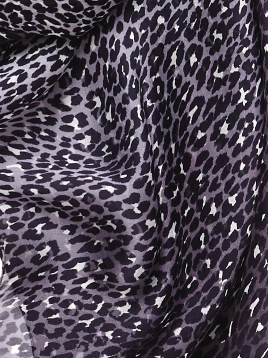 Close-up of a Jane Carr The Leopard Square in Monochrome silk voile fabric with a purple and black leopard print pattern.