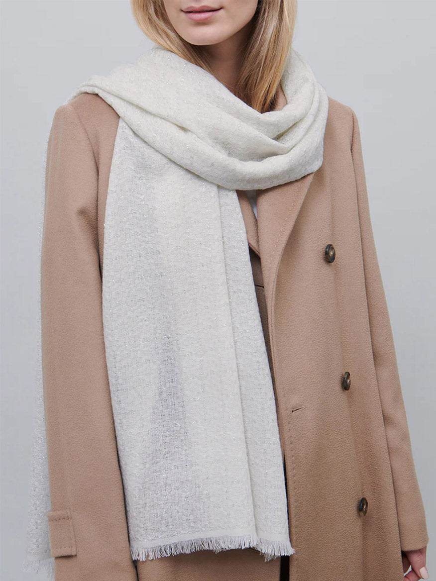 Woman wearing a beige bouclé coat and Jane Carr The Tile Scarf in White.