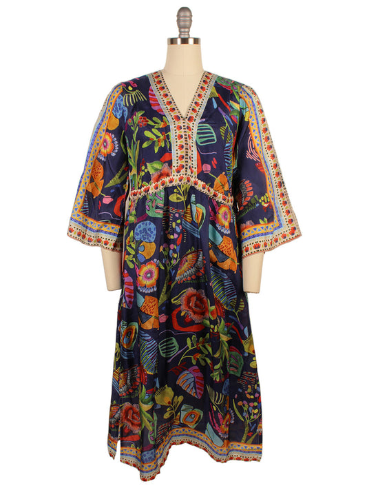 The Johnny Was Saskia Midi Dress, featuring a vibrant Farout Scarf Print with kimono sleeves and a v-neck, is elegantly showcased on a mannequin.