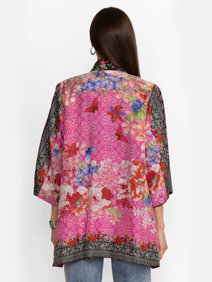 Rear view of a woman wearing a Johnny Was Yena Reversible Kimono in Rose Spark with lace trim, paired with jeans, against a white background.