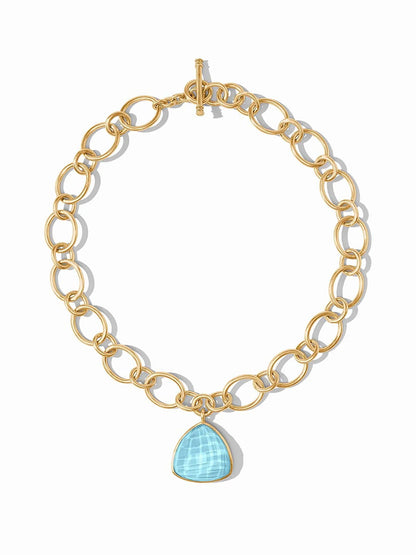 Julie Vos Aquitaine Statement Necklace in Iridescent Capri Blue with a toggle clasp and a large trillion cut gemstone pendant, displayed against a white background.