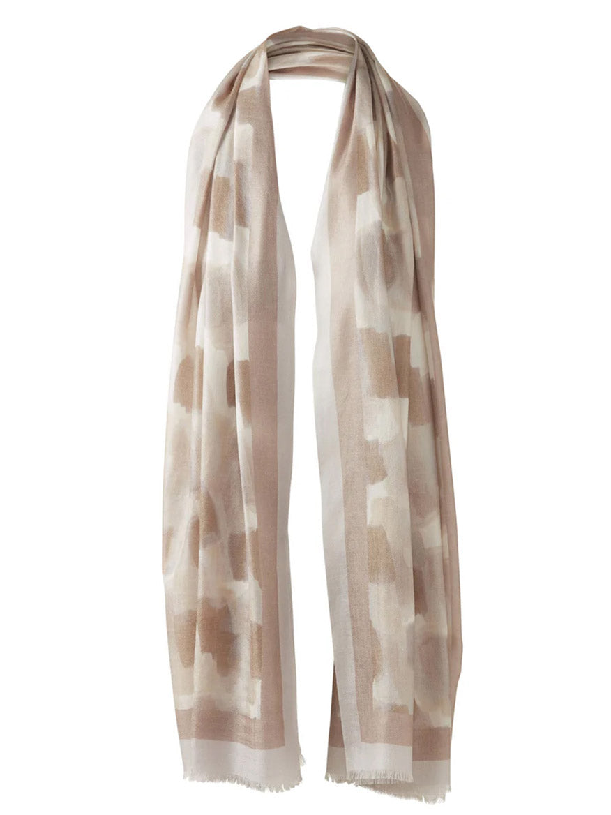 The Kinross Brushstroke Print Scarf in Straw Multi is a long, light cashmere accessory with an abstract block print, beige and white tones, and fringed edges.