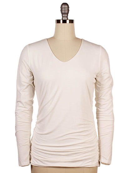 The Kinross Ruched Long Sleeve Vee in Bianco is displayed on a dress form mannequin.