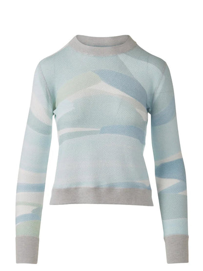 The Kinross Landscape Print Pullover in Multi is a long-sleeve cotton cashmere sweater with a light blue, white, and gray abstract print and gray ribbed cuffs, collar, and hem.
