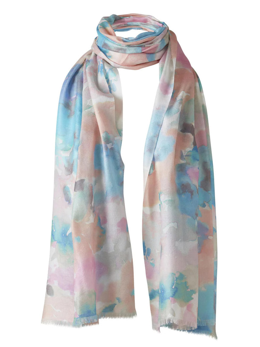 The Kinross Maldives Floral Print Scarf in Multi is a lightweight luxury scarf with soft pastel watercolor patterns of blue, pink, and beige tones, finished with short frayed edges.