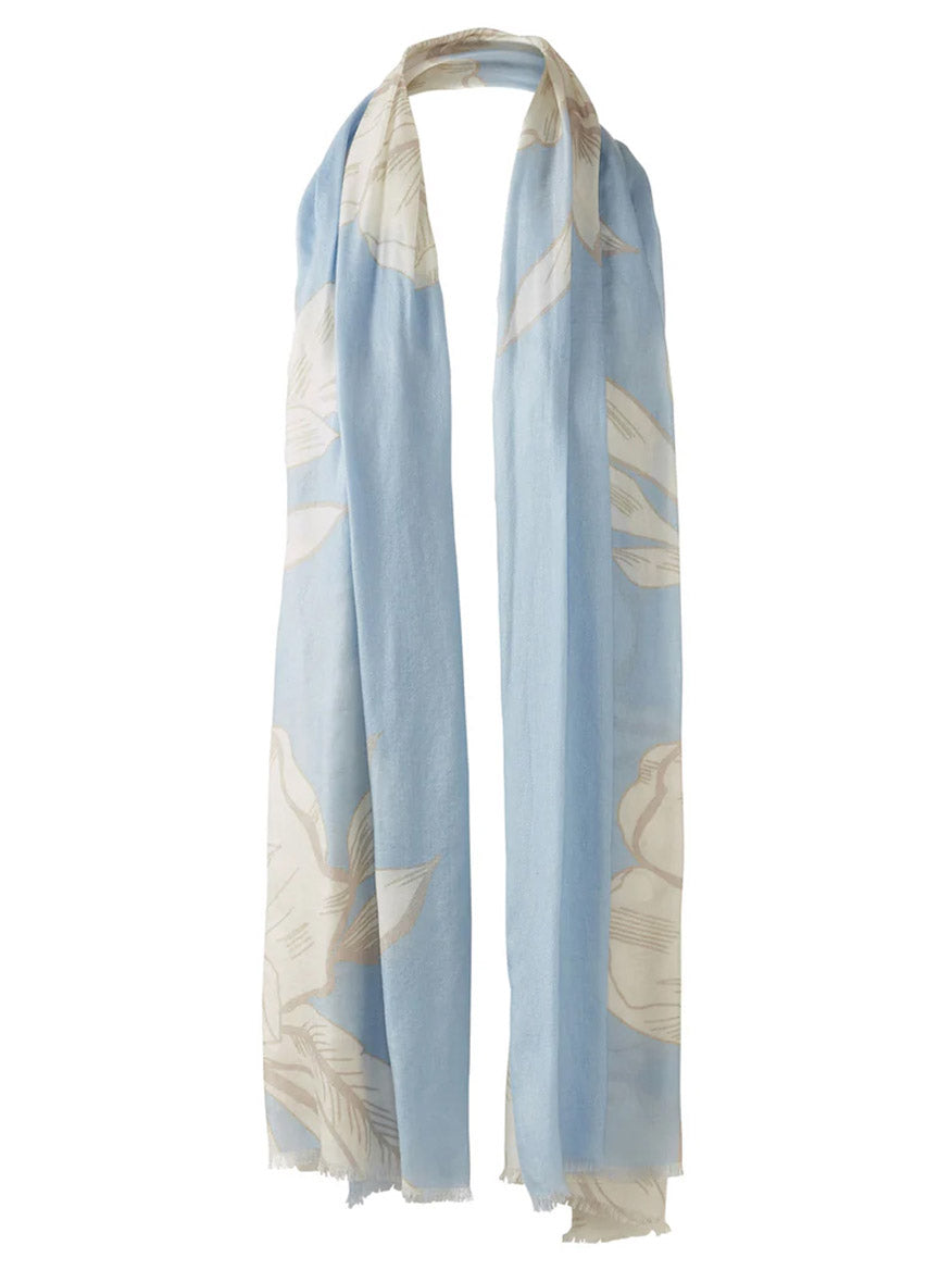 The Kinross Oversized Blooms Print Scarf in Skyway Multi features a light blue design with large beige floral motifs and frayed edges, styled in a loose loop for an effortless look.