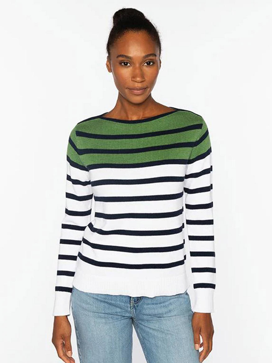 A woman stands against a white background wearing the Kinross Striped Boatneck in Navy Multi, paired with light blue jeans.