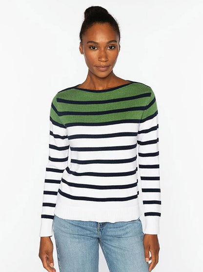 A woman stands against a white background wearing the Kinross Striped Boatneck in Navy Multi, paired with light blue jeans.