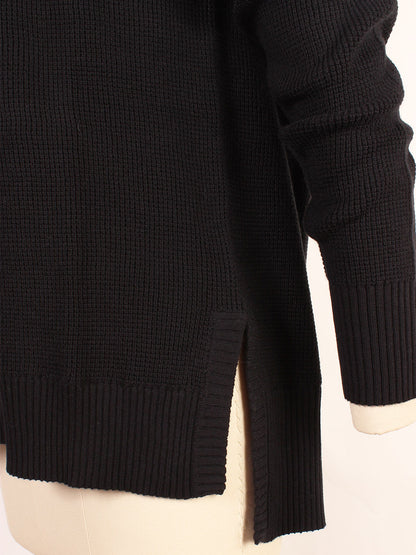 Close-up of the Kinross Thermal Hi Low Henley in Black, showcasing its detailed knit texture, side slits, and ribbed cuffs. This long-sleeve thermal garment, made from a cozy Cotton/Cashmere blend, is displayed on a mannequin.