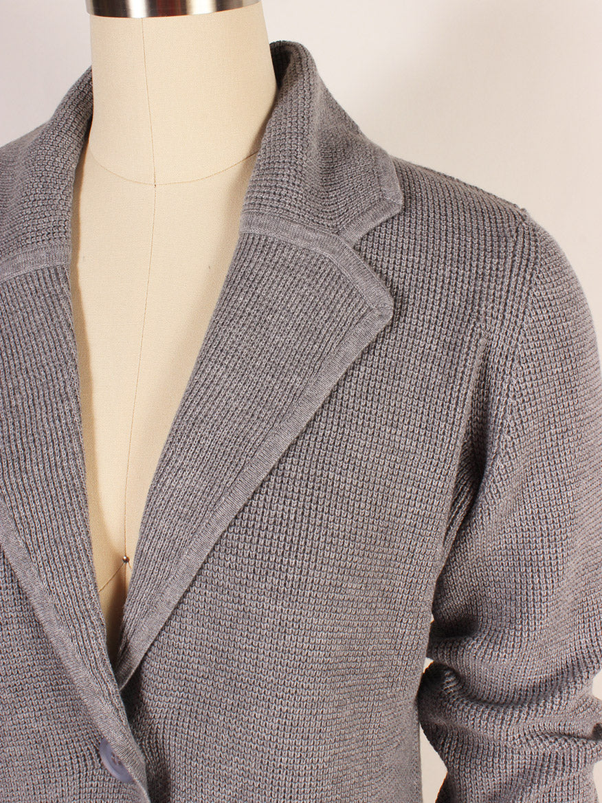 A close-up of the Kinross Thermal Notch Collar Cardigan in Granite, made from a cozy Cotton/Cashmere blend, displayed on a dress form.