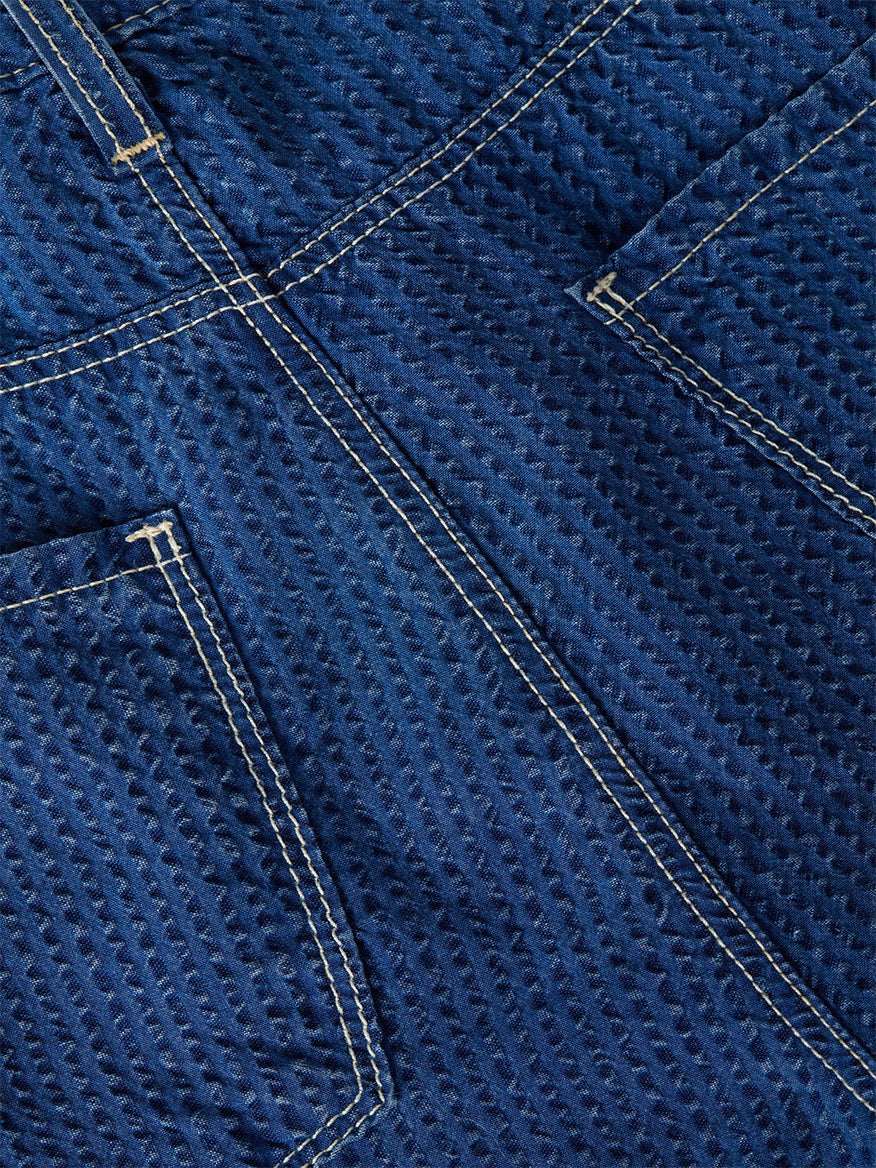 Close-up of blue textured denim with yellow double stitching and visible back pockets on the L'Agence Alicent Wide-Leg Jean in Heron, perfect for a high-rise sneaker-length style.