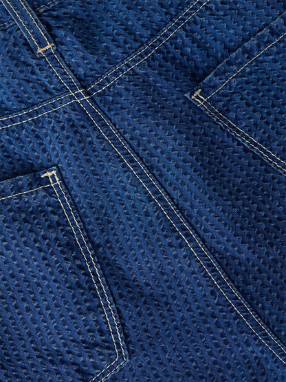 Close-up of blue textured denim with yellow double stitching and visible back pockets on the L'Agence Alicent Wide-Leg Jean in Heron, perfect for a high-rise sneaker-length style.