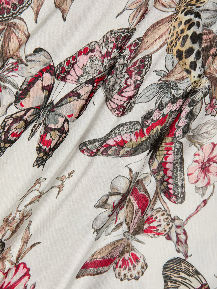 Close-up of the L'Agence Eddie Tank in White Multi Small Butterfly Jungle, showing a detailed butterfly and floral print in pink, brown, black, and cream.