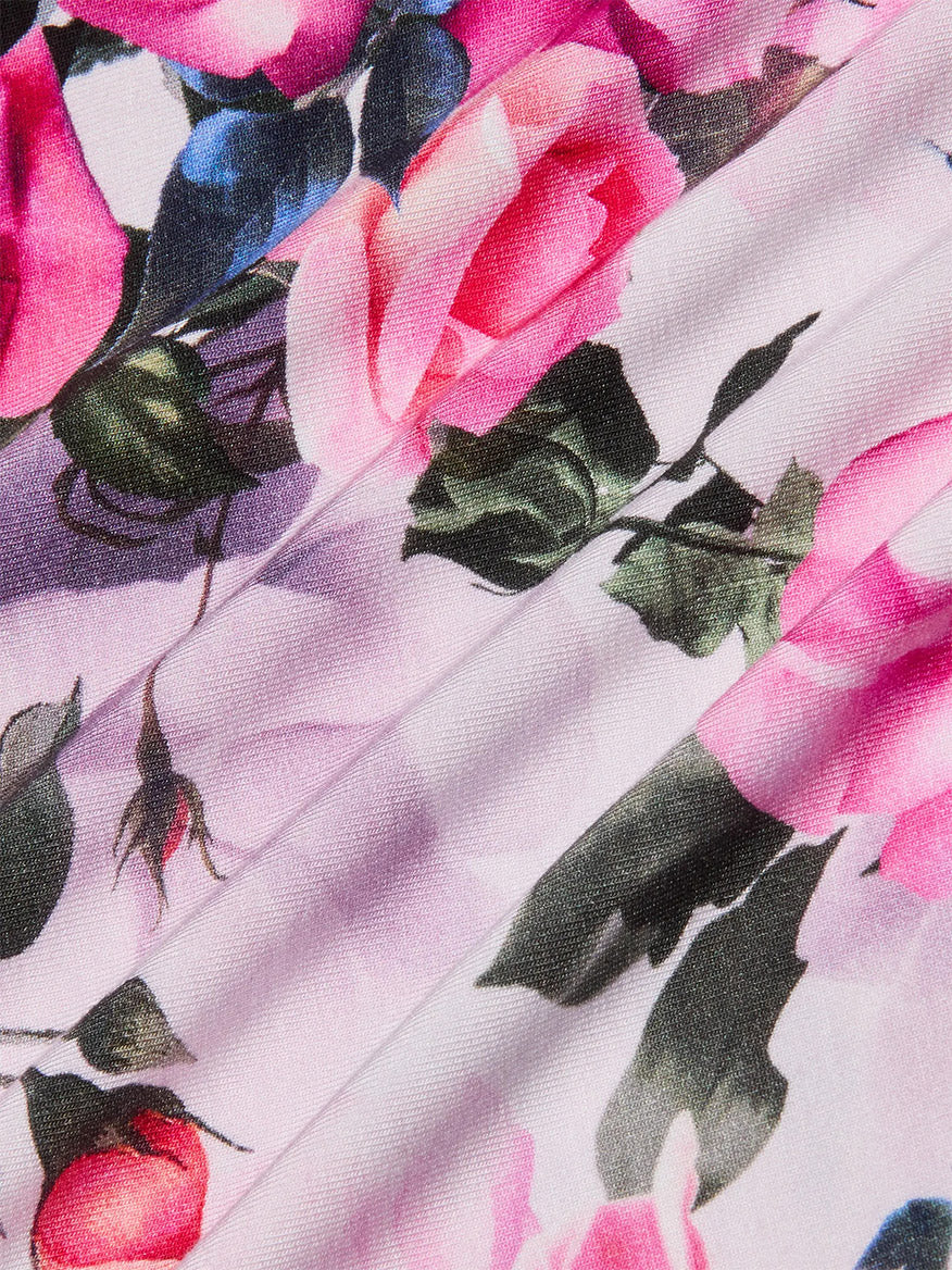 Close-up of the L'Agence Ressi Fitted Tee in Pink Multi Water Rose, highlighting pink rose print with green leaves and detailed floral patterns—perfect for those seeking a signature slim cut style.