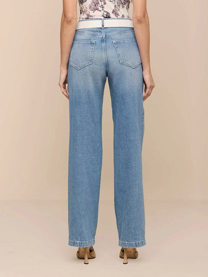 Model shown from the back in L'Agence Scottie Wide-Leg Jean in Grant, a light indigo wash high-rise denim, paired with beige heeled shoes against a neutral background.