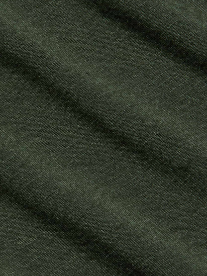 Close-up of dark green textured fabric with visible diagonal folds and a finely woven surface, reminiscent of the ultra-soft knit found in the L’Agence Aja Turtleneck in Army.