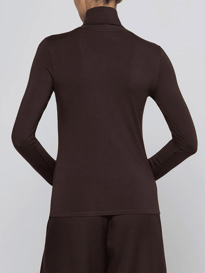 Person seen from the back wearing the L’Agence Lani Turtleneck in Dark Java, a slim fit, long-sleeve top, paired with matching dark brown pants.