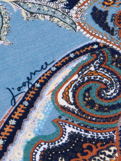 Close-up of the L’Agence Ressi Fitted Tee in Midnight Multi Besarabian Paisley, made in Los Angeles, showing blue fabric with a detailed midnight blue paisley pattern accented in orange, white, and dark blue, and featuring “J’aquena” handwritten in black ink.