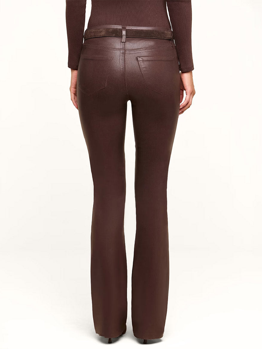 Model wearing the L’Agence Ruth Coated Straight-Leg Jean in Dark Java Coated, paired with a matching brown top, seen from the back against a plain light background.