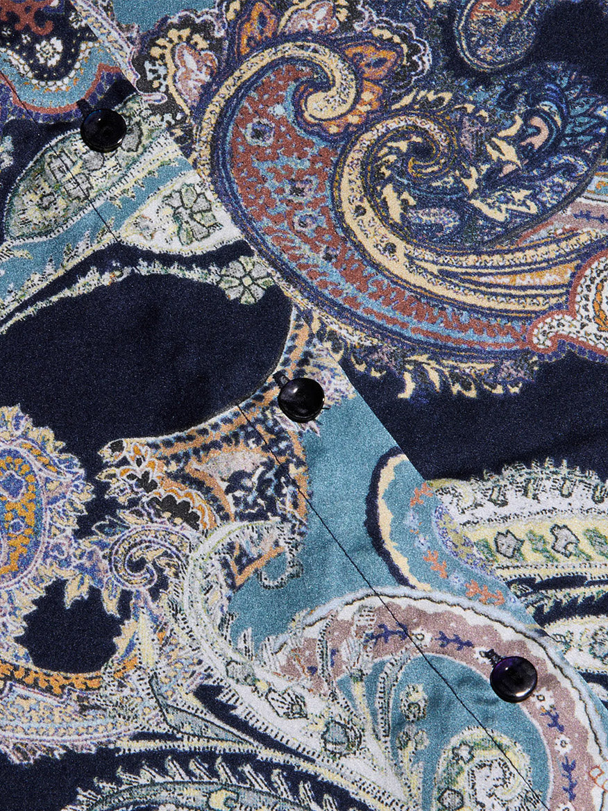 Close-up of the L’Agence Tyler Blouse in Midnight Multi Besarabian Paisley, showcasing its multicolored paisley print in blue, orange, and green tones with black buttons—perfect for a long-sleeve silk button-down.