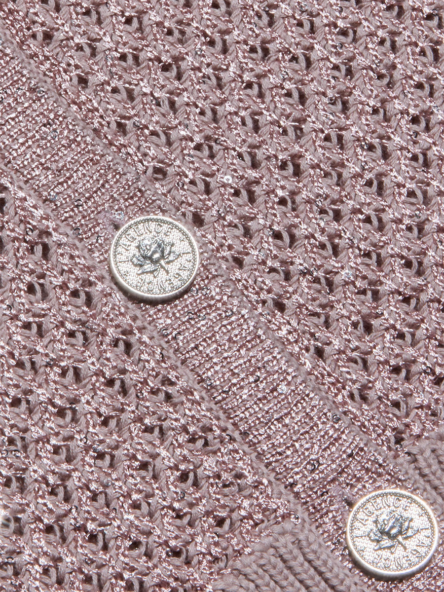 Close-up of the L'Agence Blanca Sequin Cardigan in Adobe Rose, showcasing pointelle knit fabric with a metallic sheen and two round silver embossed buttons—a perfect lightweight layer.