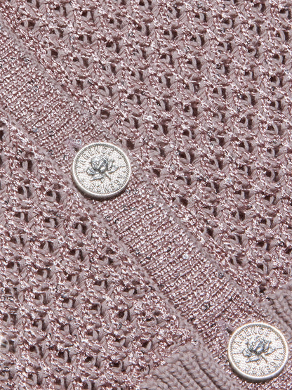 Close-up of the L'Agence Blanca Sequin Cardigan in Adobe Rose, showcasing pointelle knit fabric with a metallic sheen and two round silver embossed buttons—a perfect lightweight layer.