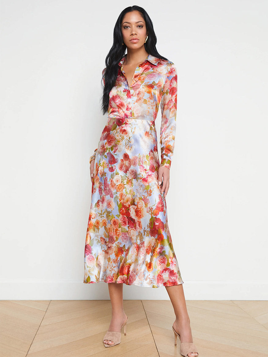A woman in a L'Agence Clarisa Silk Skirt in Multi Soft Cloud Floral standing in a room.