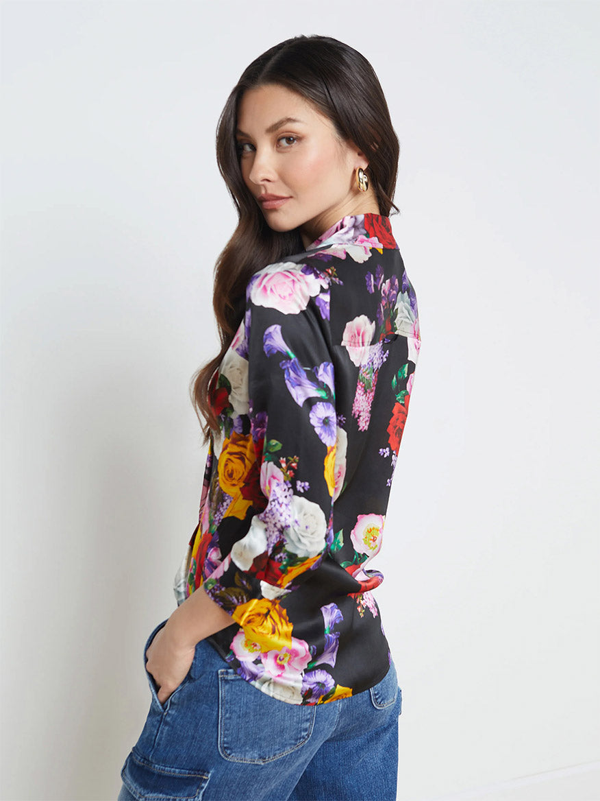 A model wearing the L'Agence Dani Blouse in Black Multi Mix Rose.