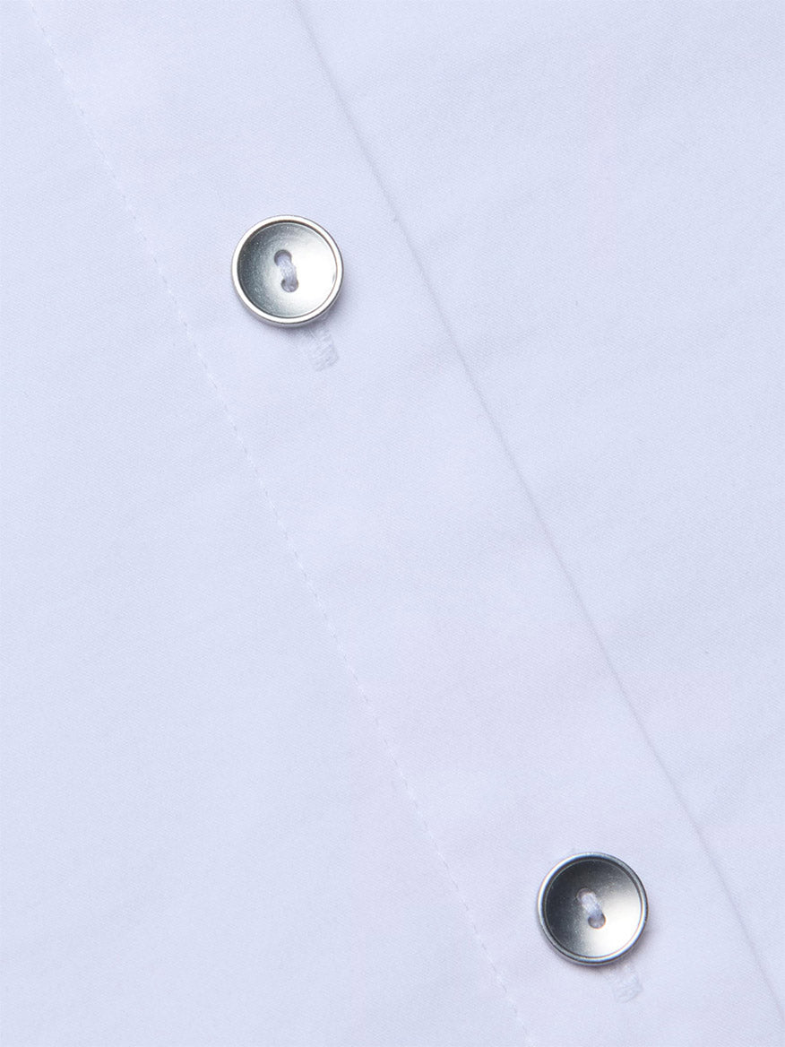 Close-up of the L'Agence Fawn Panther Print Shirt in Ivory Multi Floral Panther Scarf, highlighting two silver buttons and vertical stitching.