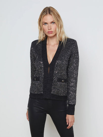 Woman posing in a L'Agence Jinny Sequin Cardigan in Black/Charcoal Sequin and black pants.
