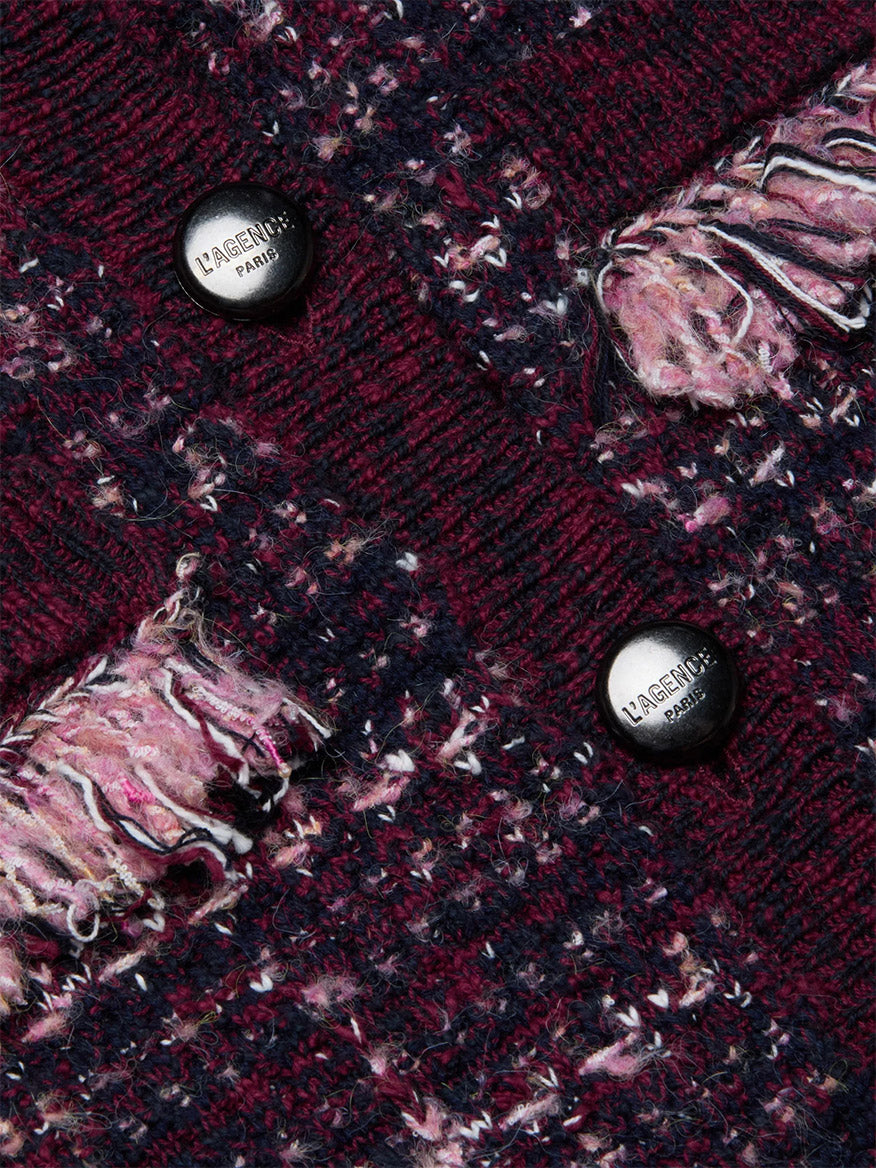 Close-up of the L'Agence Kastoria Fringe Cardigan in Black/Dark Malbec/Midnight, featuring textured maroon and pink boucle tweed, two black “L’AGENCE PARIS” buttons, and fringed pockets.