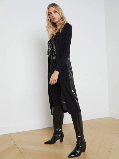 The model is wearing a L'Agence Lesia Duster Cardigan in Black Multi Grunge Chain and boots.
