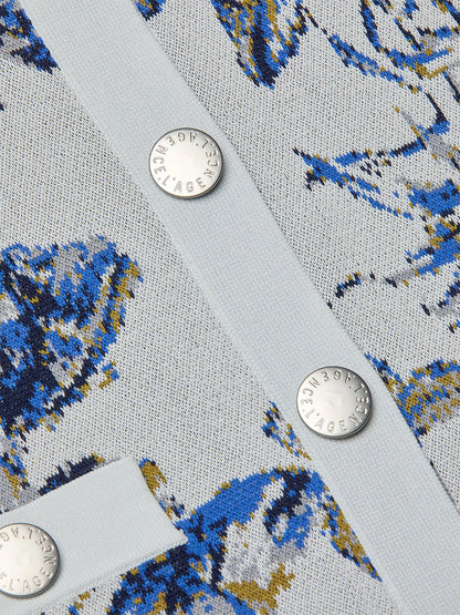 Close-up of the L'Agence Osiris Jacquard Cardigan in Grey Multi Watercolor Butterfly Jacquard, showcasing textured fabric with a blue and yellow abstract pattern and three silver snap buttons engraved with "L'Agence.