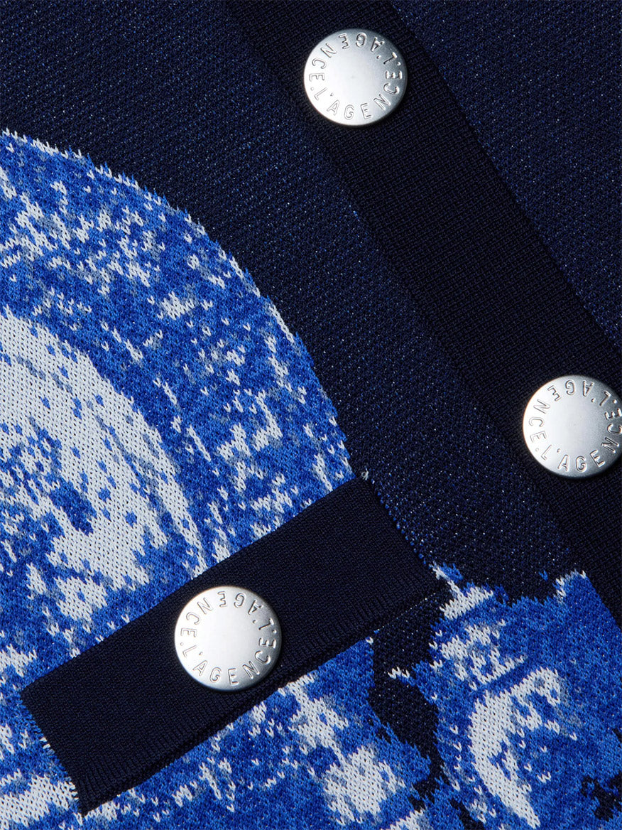 Close-up of the L'Agence Osiris Jacquard Cardigan in Black/Blue Large Porcelain, featuring jacquard woven knit fabric with metallic “JACQUEMUS” buttons and elegant porcelain motif patterns for a chic finish.