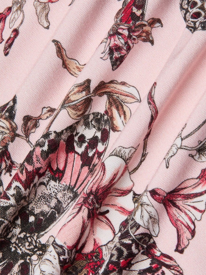 Close-up of the L'Agence Ressi Fitted Tee in Nectar Pink Multi Butterfly Jungle, showcasing pink fabric with a detailed butterfly jungle and floral print in shades of pink, black, and white.