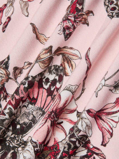 Close-up of the L'Agence Ressi Fitted Tee in Nectar Pink Multi Butterfly Jungle, showcasing pink fabric with a detailed butterfly jungle and floral print in shades of pink, black, and white.