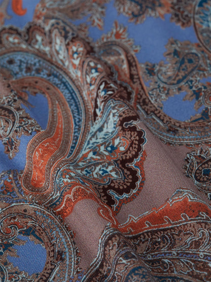 Close-up of paisley print fabric in blue and brown hues, reminiscent of the intricate design on the L'Agence Ressi Fitted Tee in Periwinkle Multi French Paisley, proudly made in Los Angeles.