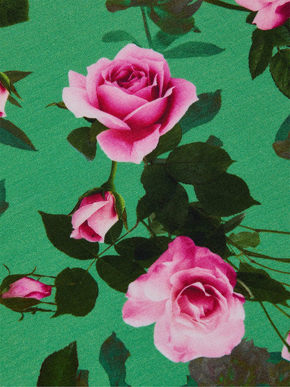 The L'Agence Ressi Fitted Tee in Green Multi Santa Fe Rose features pink roses and green leaves on a green background. This slim cut tee is made in Los Angeles for trusted quality and delivers a flattering, stylish look.