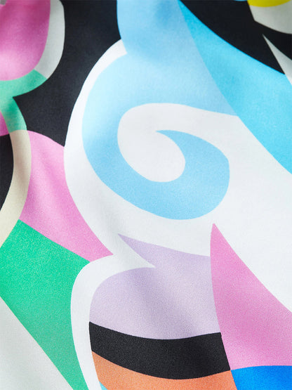 A close-up of a fabric featuring a colorful, abstract pattern with swirls and geometric shapes in blue, pink, green, and orange hues—ideal for crafting a versatile wardrobe staple like the L'Agence Tyler Blouse in Small Multi Kaleidoscope.