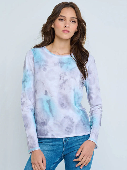 Woman wearing the Lisa Todd Brush Stroke Long Sleeve Crew in White/Blue, made from premium cotton, paired with blue jeans against a light background.