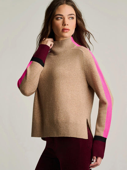 Woman wearing the Lisa Todd High Spirits Mock in Biscuit with pink and black striped sleeves and burgundy pants, standing against a neutral background.