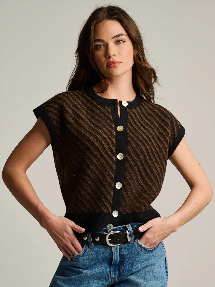 Lisa Todd In Vest in Black Combo, a sleeveless, button-front knit vest featuring a black and brown diagonal wavy pattern, worn with blue jeans.
