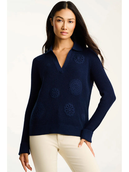 A woman wearing the Lisa Todd Knit Bliss Cotton Sweater in Navy and beige pants stands against a plain, light background.