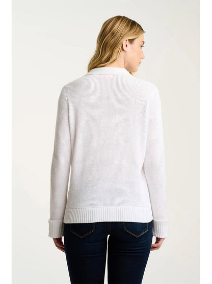 A woman with blonde hair, seen from behind, wears the Lisa Todd Knit Bliss Cotton Sweater in White paired with dark blue jeans against a plain background.