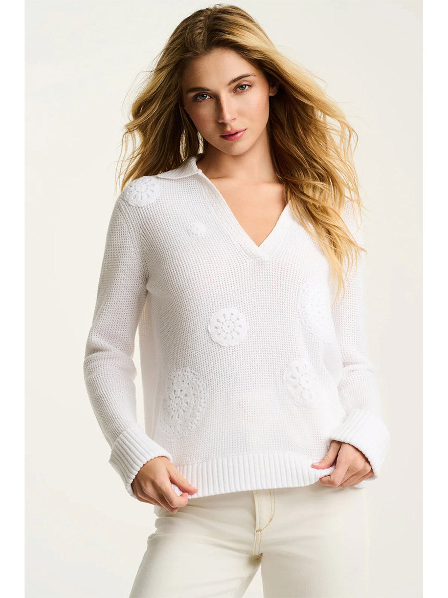 A woman wearing the Lisa Todd Knit Bliss Cotton Sweater in White and white pants stands against a plain light background, radiating knit bliss.
