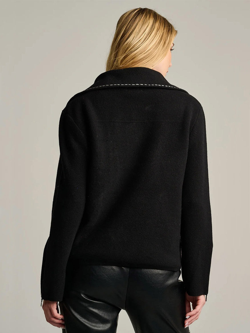 Back view of a person wearing a black Lisa Todd Moto Stitch Jacket with white topstitching along the collar.