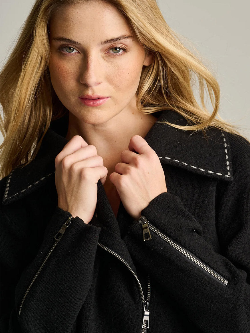 Lisa Todd Moto Stitch Jacket in black knit featuring white decorative stitching on the collar and silver zipper hardware.