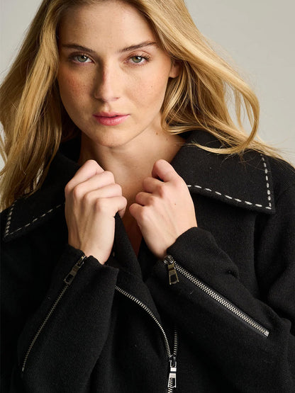 Lisa Todd Moto Stitch Jacket in black knit featuring white decorative stitching on the collar and silver zipper hardware.