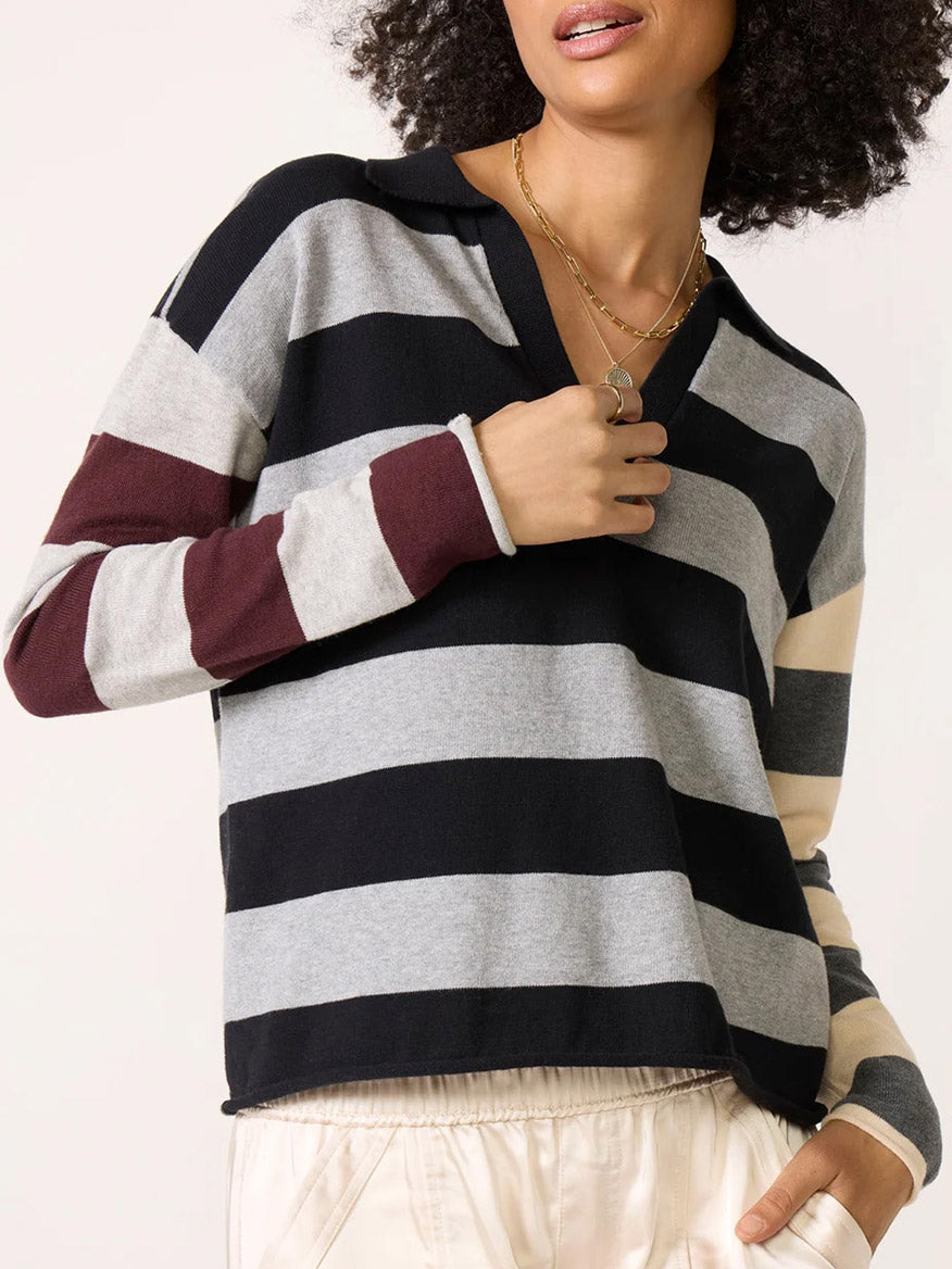 A Lisa Todd Perfect Pitch Collared V in Black/Grey cotton knit pullover with a V-neck, a small collar, and horizontal stripes in black, grey, maroon, and cream.